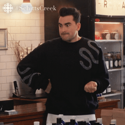 A Man In A Black Sweater With The Word Schitts Creek On It GIF