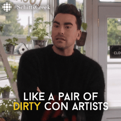 A Man In A Black Sweater With The Words Like A Pair Of Dirty Con Artists On The Bottom GIF
