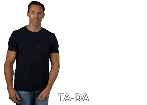 A Man In A Black T-Shirt And Jeans Is Standing In Front Of A White Background With Ta-Da Written On It GIF