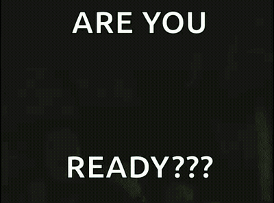 A Man In A Black Tank Top Is Holding A Sign That Says Are You Ready GIF