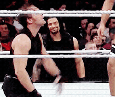 A Man In A Black Tank Top Is In A Boxing Ring GIF