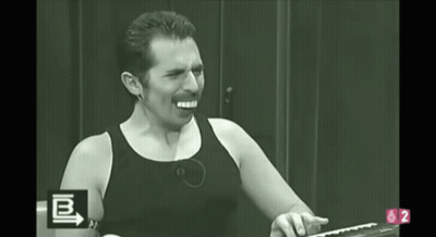 A Man In A Black Tank Top Is Screaming In A Black And White Photo With The Letters B And 2 In The Corner GIF