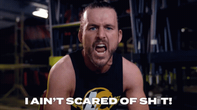 A Man In A Black Tank Top Is Screaming With The Words I Ain 'T Scared Of Shit Below Him GIF
