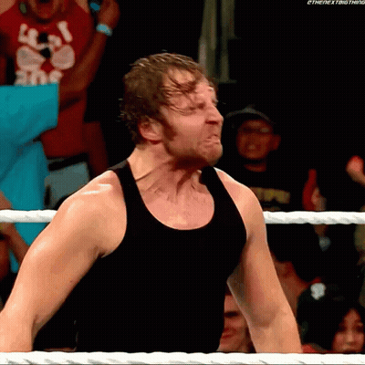 A Man In A Black Tank Top Is Standing In A Wrestling Ring With The Next Thing Written On The Bottom GIF