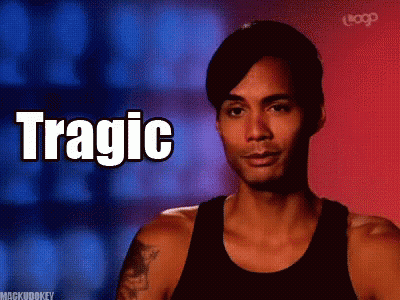 A Man In A Black Tank Top With The Word Tragic Written On It GIF