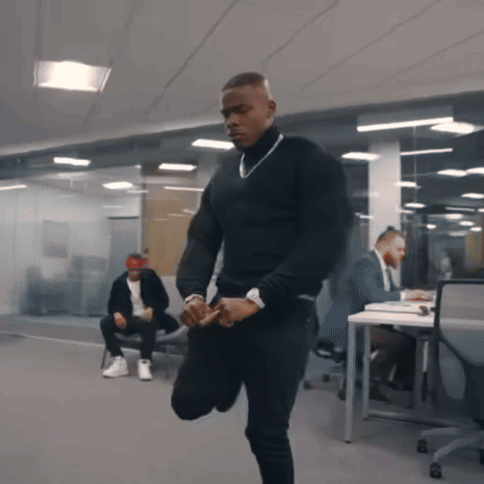 A Man In A Black Turtleneck Sweater Is Kneeling Down GIF