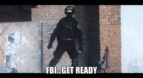 A Man In A Black Uniform Is Standing In Front Of A Brick Wall And Says Fbi Get Ready GIF