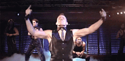 A Man In A Black Vest And Tie Giving The Middle Finger GIF