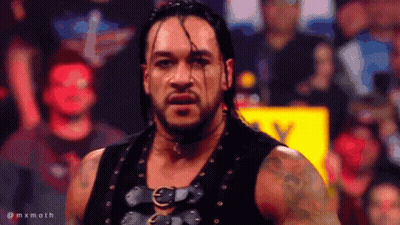A Man In A Black Vest Stands In Front Of A Crowd With The Hashtag Mxmoth On The Bottom Right GIF