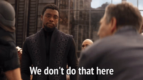 A Man In A Black Vest Stands In Front Of A Group Of People And Says We Don 'T Do That Here GIF