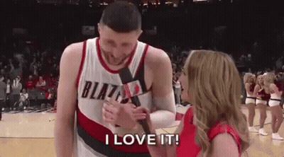 A Man In A Blazers Jersey Is Being Interviewed By A Woman Holding A Microphone . GIF