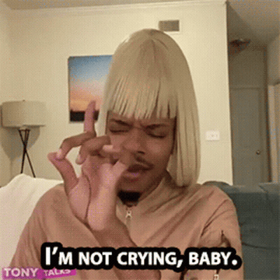 A Man In A Blonde Wig Is Sitting On A Couch And Says I 'M Not Crying Baby GIF
