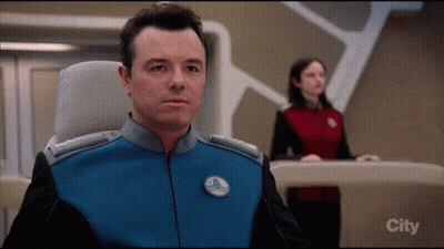 A Man In A Blue And Black Uniform Is Sitting In Front Of A Screen That Says City GIF