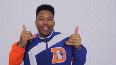 A Man In A Blue And Orange Jacket With The Letter D On It GIF