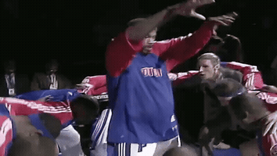 A Man In A Blue And Red Shirt With The Word Pistons On It GIF