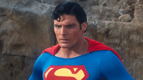 A Man In A Blue And Red Superman Costume GIF