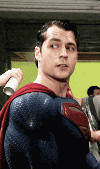 A Man In A Blue And Red Superman Costume GIF