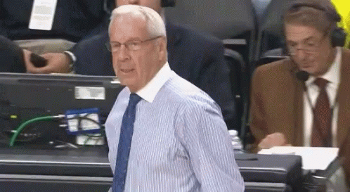 A Man In A Blue And White Striped Shirt And Tie GIF