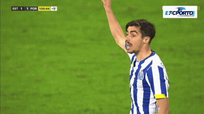A Man In A Blue And White Striped Shirt Holds Up His Fist GIF