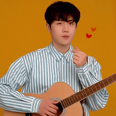 A Man In A Blue And White Striped Shirt Is Holding A Guitar GIF