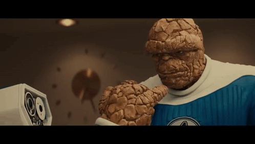 A Man In A Blue And White Superhero Costume GIF