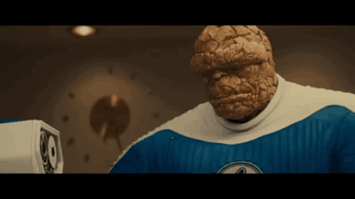 A Man In A Blue And White Superhero Costume With The Word Thing On It GIF