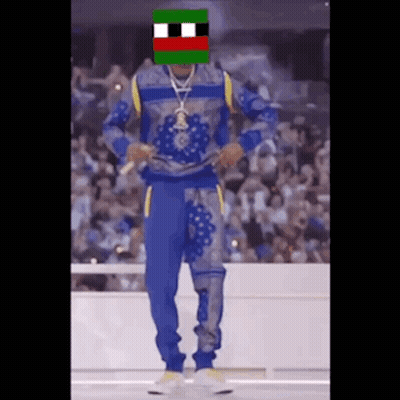 A Man In A Blue And Yellow Outfit Is Dancing In Front Of A Crowd GIF