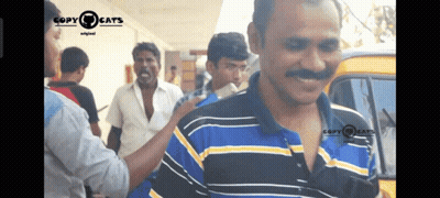 A Man In A Blue And Yellow Striped Shirt Is Being Touched By Another Man In A Copy Cats Video GIF