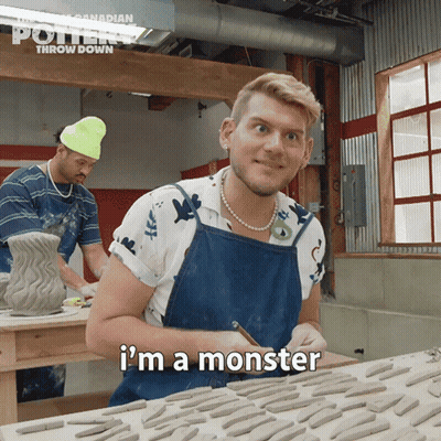 A Man In A Blue Apron Says I 'M A Monster In Front Of A Table Full Of Clay GIF