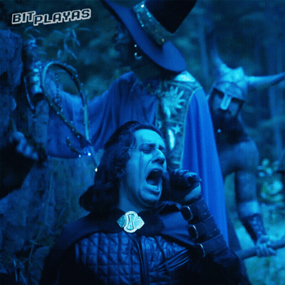 A Man In A Blue Cape Stands Next To A Man In A Black Hat With The Words Bitplayas On The Bottom Right GIF