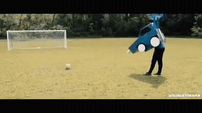 A Man In A Blue Car Costume Is Kicking A Soccer Ball . GIF