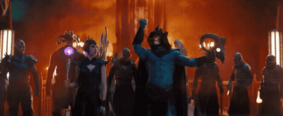 A Man In A Blue Costume Is Holding A Purple Object GIF