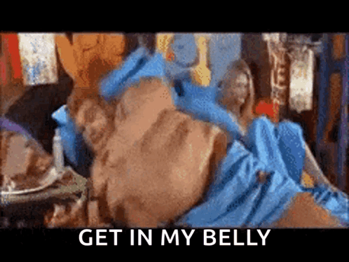 A Man In A Blue Dress Is Laying On A Bed With The Words `` Get In My Belly '' Written On The Bottom GIF