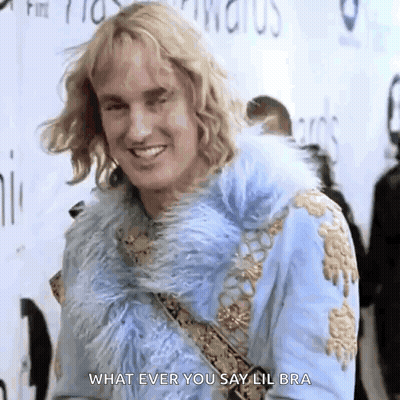 A Man In A Blue Fur Coat Is Smiling And Saying What Ever You Say Lil Bra GIF