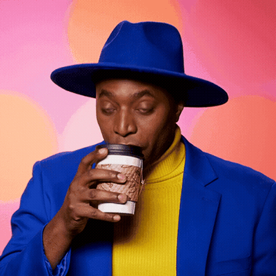 A Man In A Blue Hat Drinking From A Cup GIF