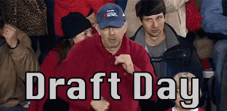 A Man In A Blue Hat Is Dancing In A Crowd Of People With The Words Draft Day Written Above Him GIF