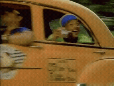 A Man In A Blue Hat Is Drinking From A Cup While Sitting In A Car . GIF