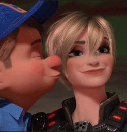A Man In A Blue Hat Kisses A Woman On The Nose GIF