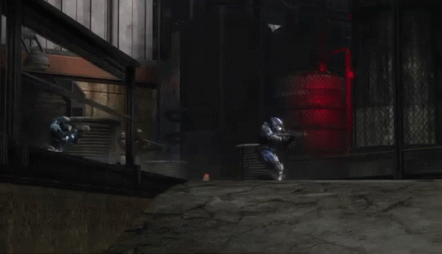 A Man In A Blue Helmet Is Holding A Gun In A Field . GIF