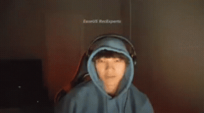 A Man In A Blue Hoodie And Headphones Is Making A Funny Face . GIF