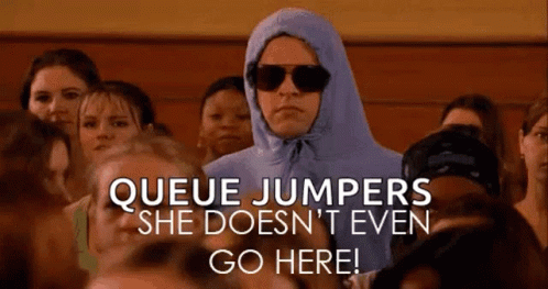 A Man In A Blue Hoodie And Sunglasses Is Standing In Front Of A Crowd Of People . GIF