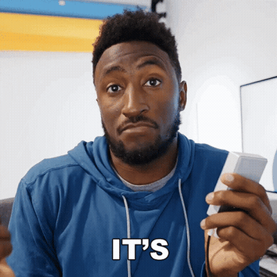 A Man In A Blue Hoodie Holds A Remote Control And Says It 'S In White Letters GIF