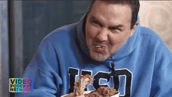 A Man In A Blue Hoodie Is Eating Fried Chicken GIF