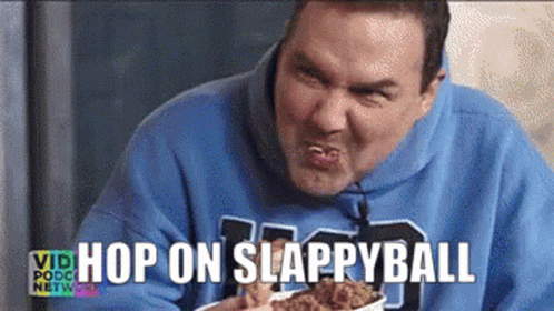 A Man In A Blue Hoodie Is Eating Fried Chicken With The Words Hop On Slappyball Above Him GIF