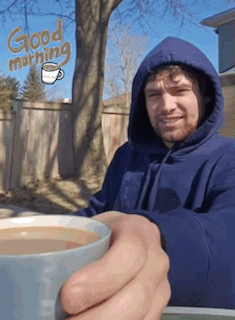 A Man In A Blue Hoodie Is Holding A Cup Of Coffee With The Words Good Morning Written In The Background GIF