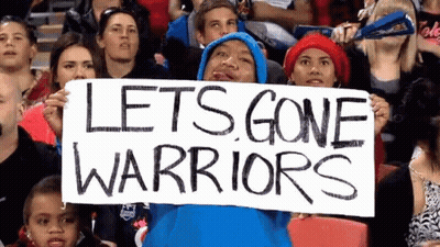 A Man In A Blue Hoodie Is Holding A Sign That Says Let 'S Gone Warriors GIF