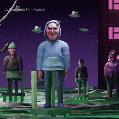A Man In A Blue Hoodie Is Standing In Front Of A Sign That Says La Guarimba Film Festival On It GIF