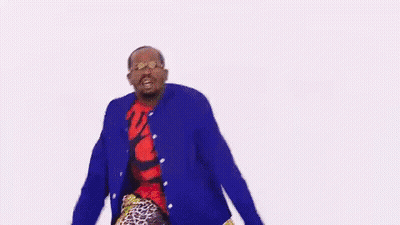 A Man In A Blue Jacket And Red Shirt Is Dancing . GIF