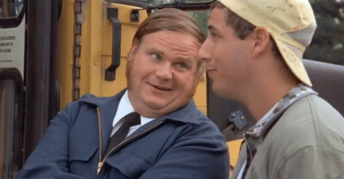 A Man In A Blue Jacket And Tie Is Talking To Another Man In A Baseball Cap . GIF