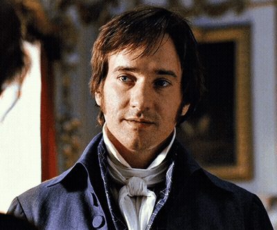 A Man In A Blue Jacket And White Tie GIF